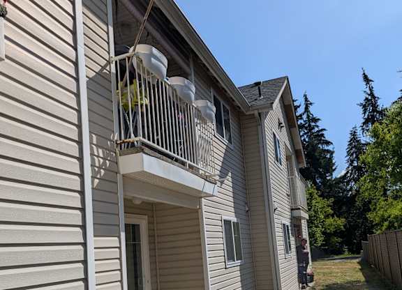 A house with a balcony and a chair on it.