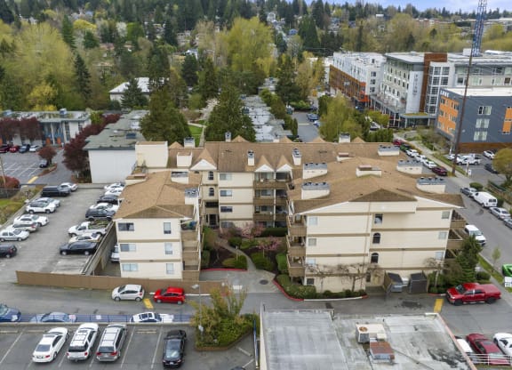 an aerial view of a parking lot and buildings in a city