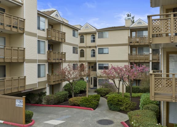an exterior view of an apartment building with balconies and trees