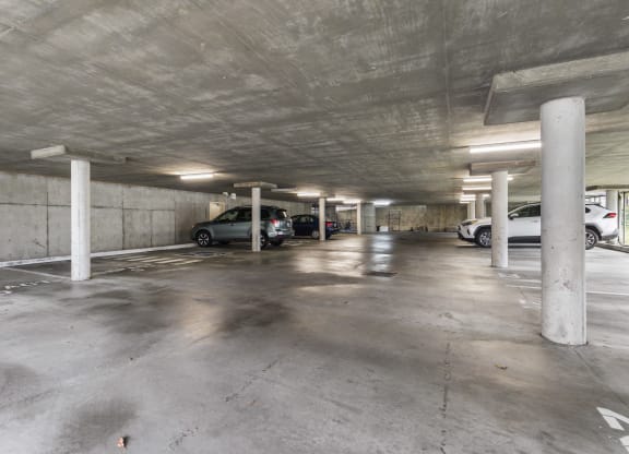 the interior of a parking garage with cars