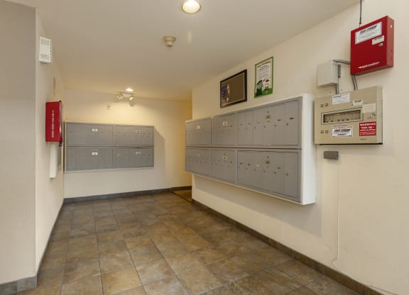 a utility room with lockers and mailboxes on the wall