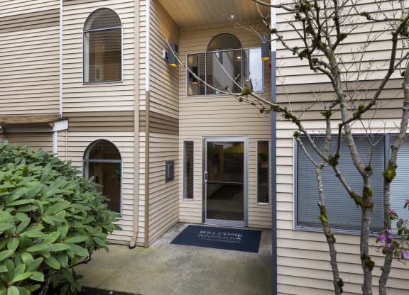 the outside of a house with a front door and a sidewalk