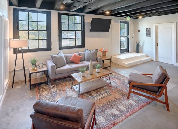 a living room with couches and chairs and a tv