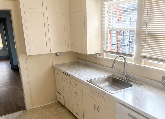 A kitchen with a sink and cabinets.