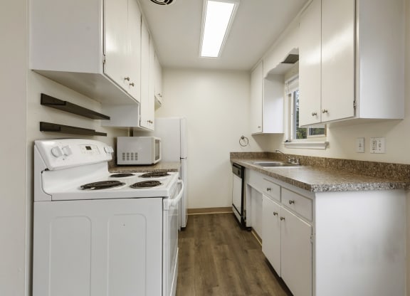 a kitchen with white appliances and white cabinets