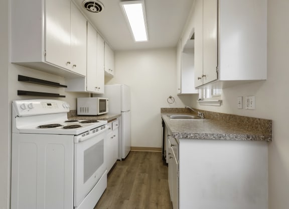 a kitchen with white appliances and white cabinets