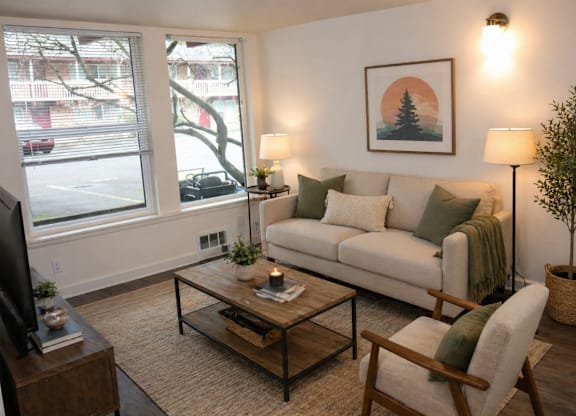 A living room with a couch, chair, and a coffee table.