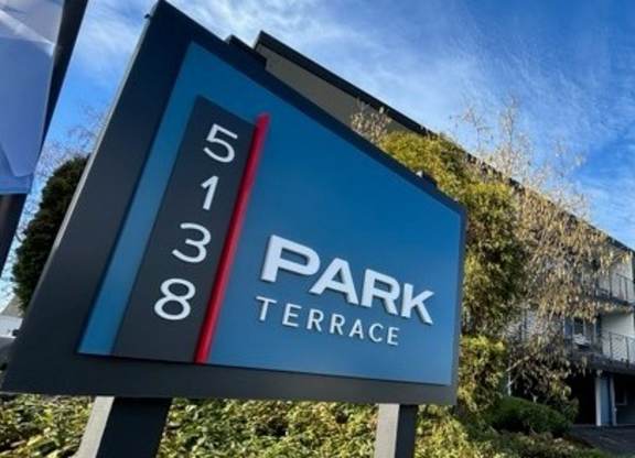 A sign for Park Terrace stands in front of a building.