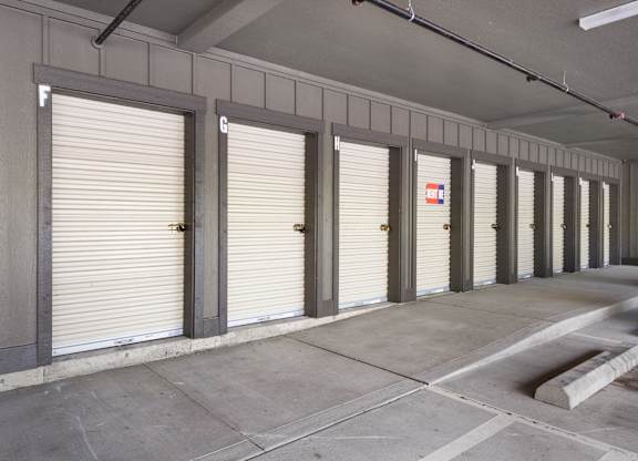 A long row of garage doors are closed.