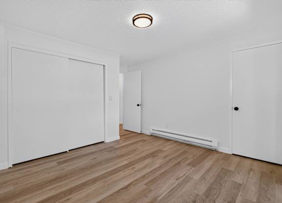 A room with a wooden floor and white walls.