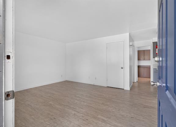 A room with a white door and a white wall.
