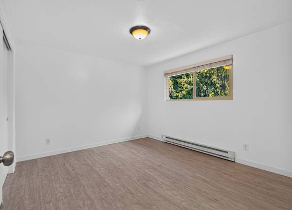 A room with a window and a door.