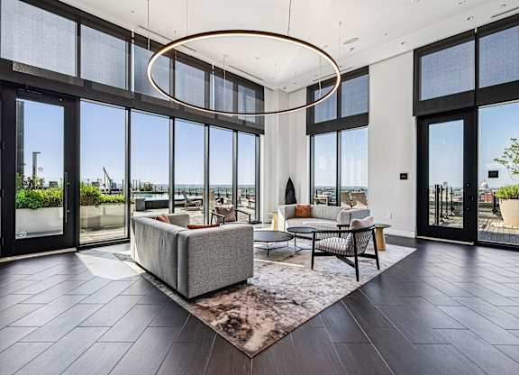 A modern living room with a large window overlooking the ocean.