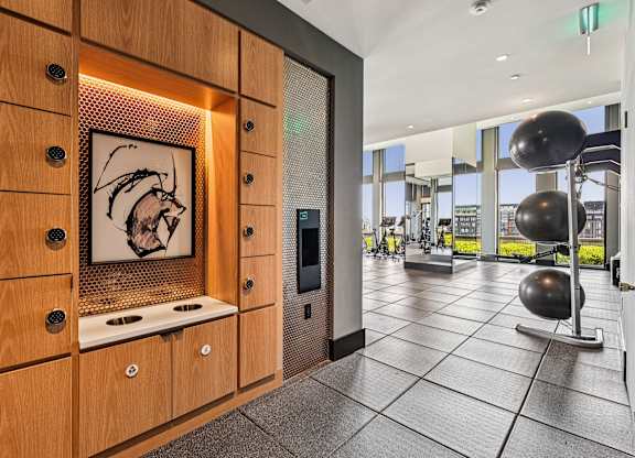 A modern kitchen with wooden cabinets and a fridge.