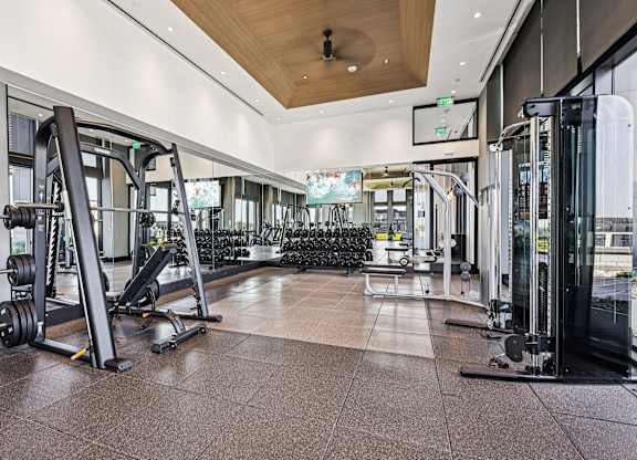 A gym with a variety of equipment including a leg press machine.