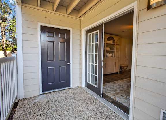 A grey door is on the left and a glass door is on the right.