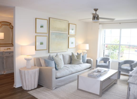 a living room with a couch and a coffee table at Vineyard at Castlewoods in Brandon, MS