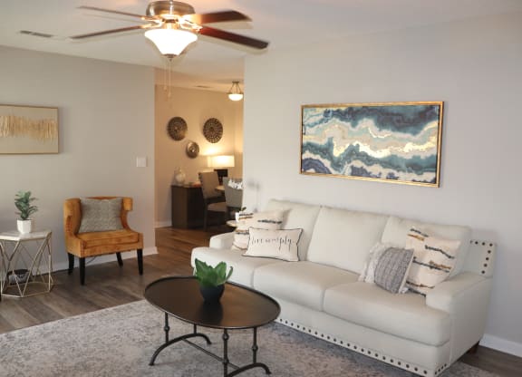 a living room with a couch and a coffee table  at Laurelwood Apartment Homes, 39440