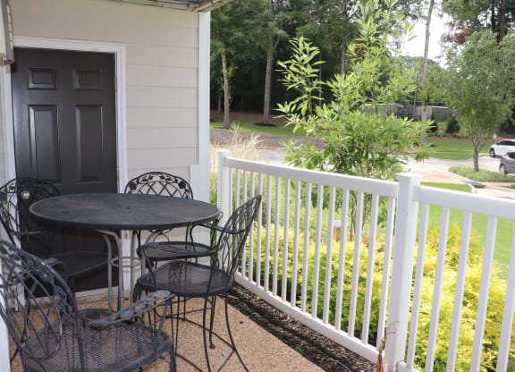 a patio with a table and chairs on a porch  at Laurelwood Apartment Homes, Laurel, Mississippi, 39440