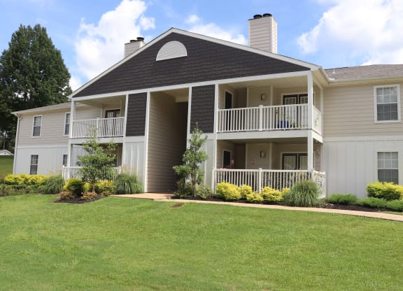 the view of a house with a porch and a lawn  at Laurelwood Apartment Homes, Mississippi