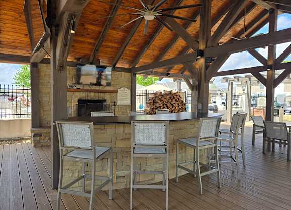A wooden deck with a table and chairs.