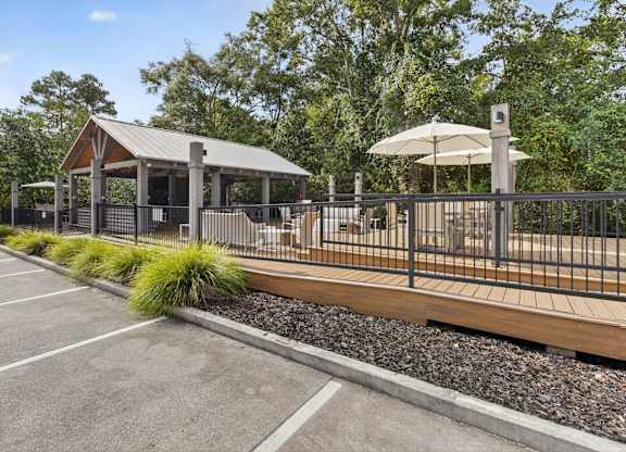 A parking lot with a gazebo and a fence.