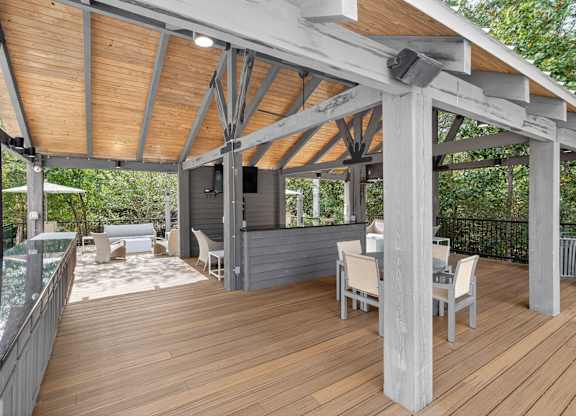 A wooden deck with a table and chairs.