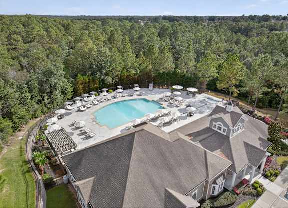 A large house with a pool and a hot tub.