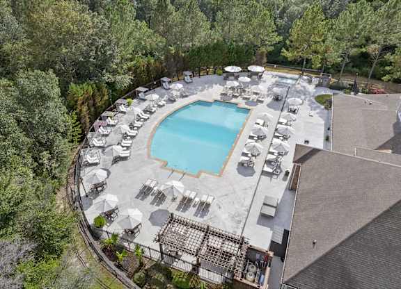 drone photos of charleston apartment homes in mobile, alabama showing their pool and new pool furniture