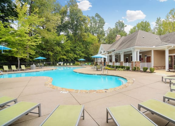 Resort style pool with lounge chairs at Highlands Apartment Homes, Bartlett