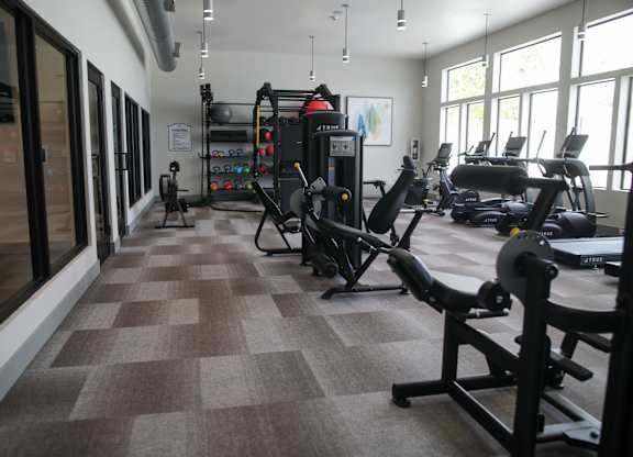 A gym with a variety of equipment including treadmills, weights, and exercise machines. at The Azul Apartment Homes, Mississippi, 38655