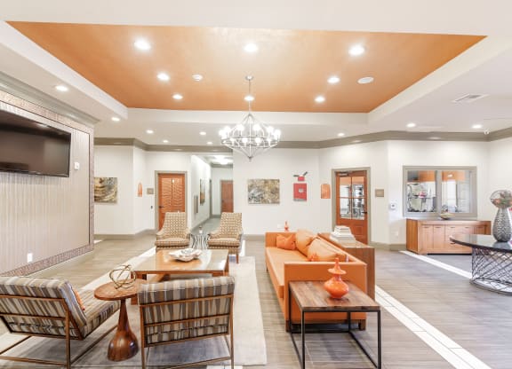a living room with couches and chairs and a television at Cumberland Place Apartment Homes, Tyler, Texas