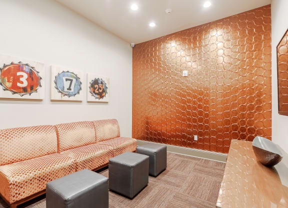 a room with couches and a table and paintings on the wall at Cumberland Place Apartment Homes, Tyler