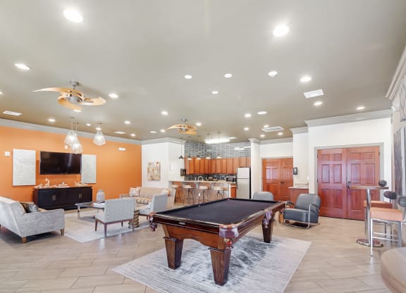 a game room with a pool table and a bar at Cumberland Place Apartment Homes, Tyler, TX 75703
