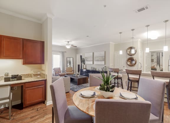 a living room and dining room with a table and chairs at Cumberland Place Apartment Homes, Tyler