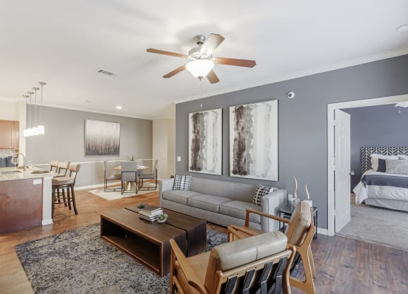 a living room with a couch and a ceiling fan at Cumberland Place Apartment Homes, Texas