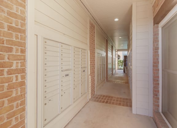 a long hallway with white mailboxes on the side of a house at Cumberland Place Apartment Homes, Texas