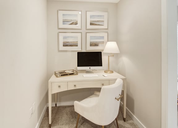 a home office with a computer desk and a white chair at The Azul Apartment Homes in Mississippi 38655