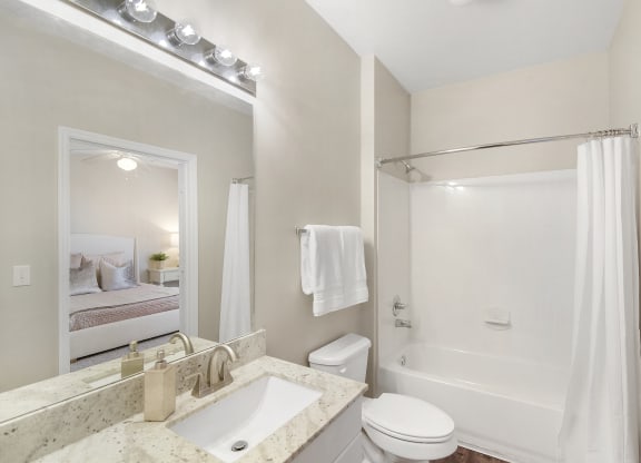 Bathroom with a sink toilet and shower and a mirror at Highlands Apartment Homes, Bartlett, 38135