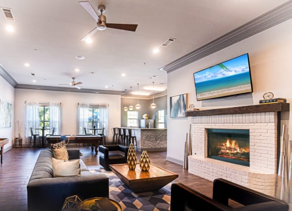 the living room has a fireplace and a seating area  at The Madison Apartment Homes in Tyler, 75703