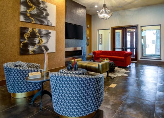 a living room with a couch and tables and a television at The Retreat Apartment Homes in Williston, North Dakota 58801