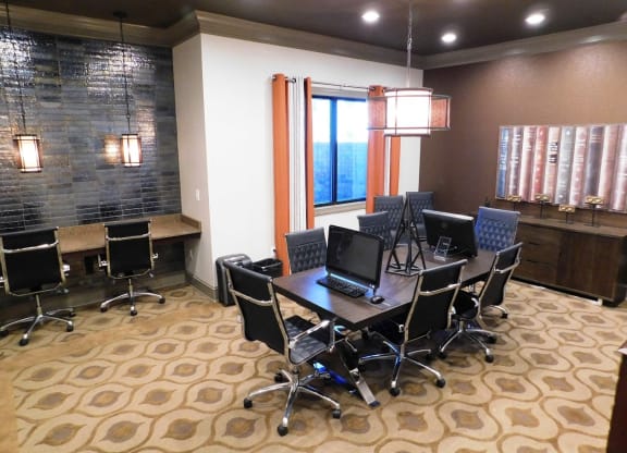 a conference room with a table with computers and chairs at Reserve at Gulf Hills Apartment Homes in Ocean Springs, MS 39564