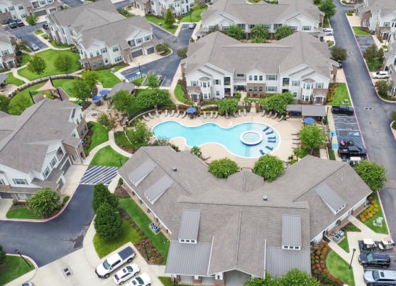 an aerial view of a community swimming pool surrounded by houses at Kingston Crossing Apartment Homes, Bossier City, 71111