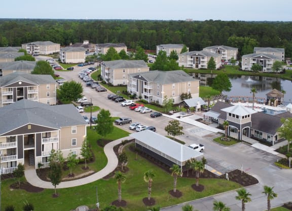 an aerial view of a community with houses and a lake at Reserve at Gulf Hills Apartment Homes in Mississippi 39564