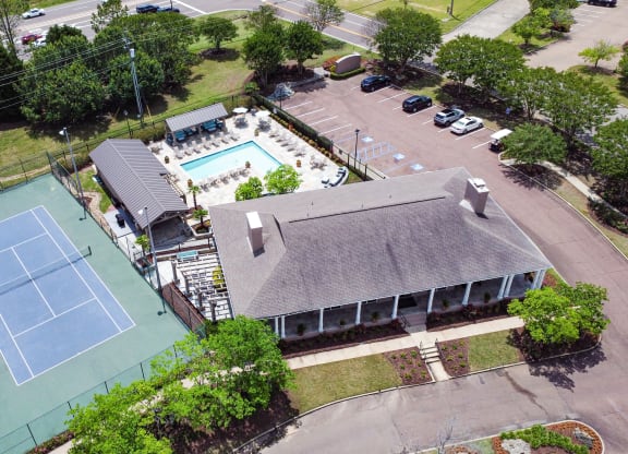 an aerial view of a tennis court and a building with a pool at Highpointe Apartment Homes, Brandon, 39042