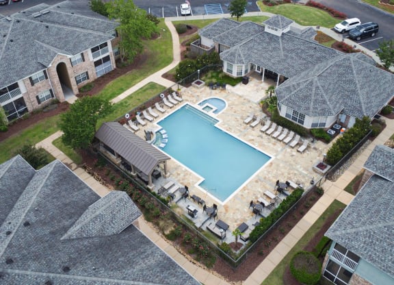 an aerial view of a swimming pool in a home with umbrellas at Ashford Place Apartment Homes, Flowood