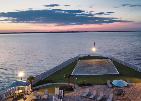 a view of the pool and the water at dusk  at Lakeshore Pointe Apartment Homes, Brandon