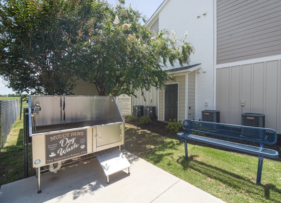 a grill and a bench in front of a building at Reserve of Bossier City Apartment Homes in LA 71111