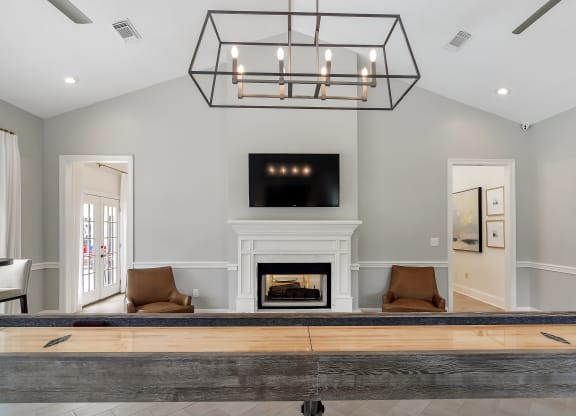 a living room with a fireplace and a table at Bridgewater Apartment Homes, Mississippi 39047