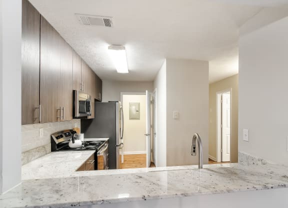 a kitchen with granite counter tops and a stove and refrigerator at Bridgewater Apartment Homes, Brandon, Mississippi